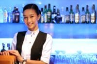 female bartender about to check patrons id