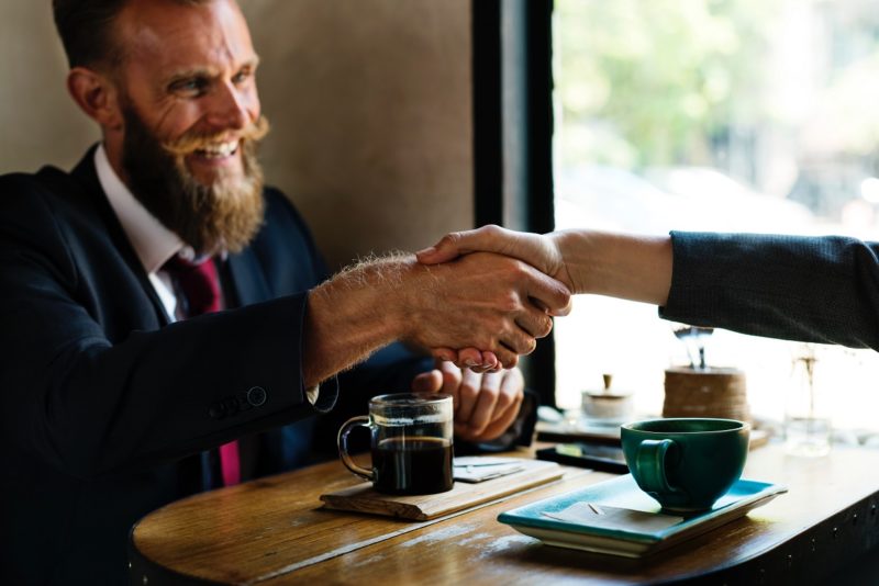 businessman handshake at coffee shop