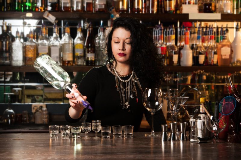 female bartender serving cocktail