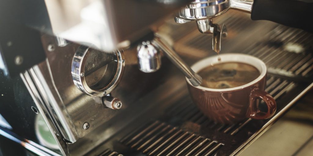 espresso machine pouring coffee in cups